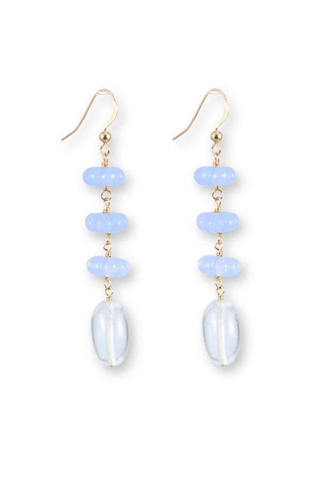 Pair of earrings with blue and white stones on a white background