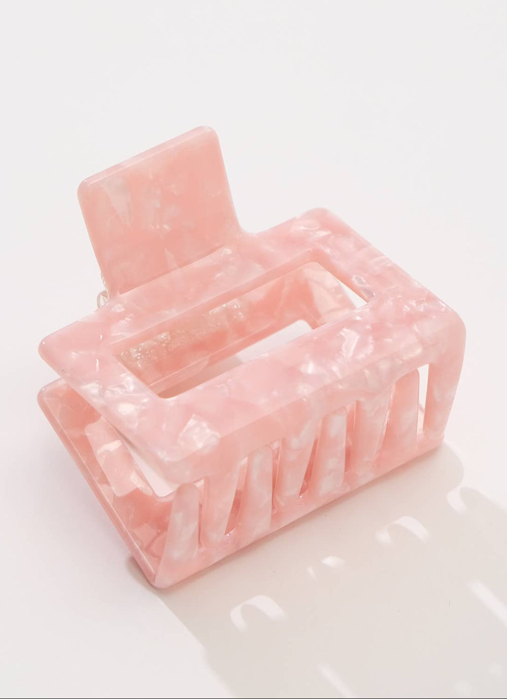 Pink marble-patterned hair clip on a white background