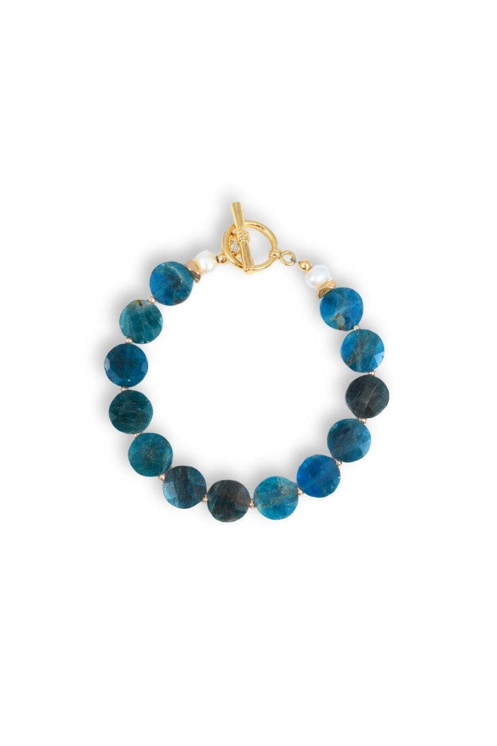 A beaded bracelet featuring round, polished blue and dark gray-green stones, accented with small white beads and finished with a gold toggle clasp, shown on a plain white background.