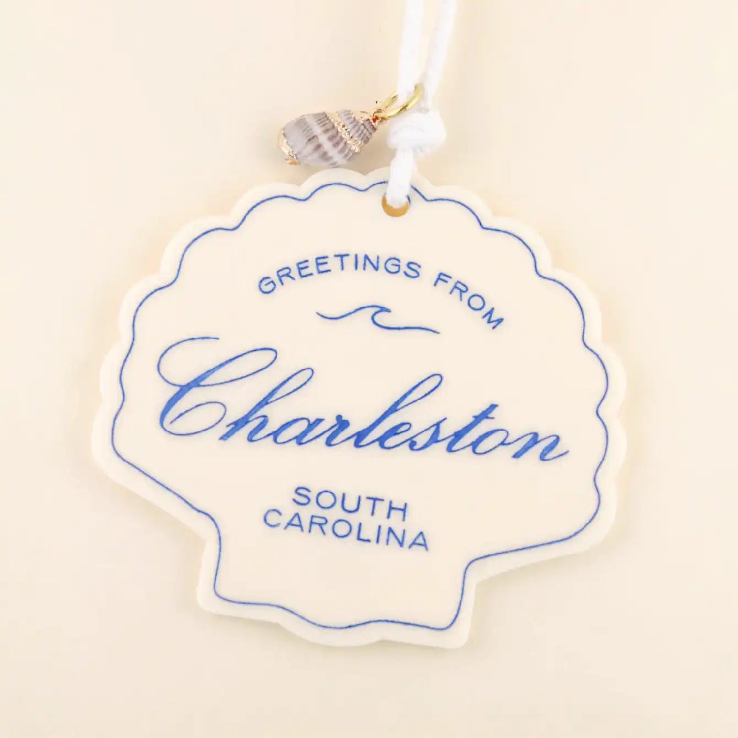 Decorative ornament with 'Greetings from Charleston, South Carolina' text on a beige background