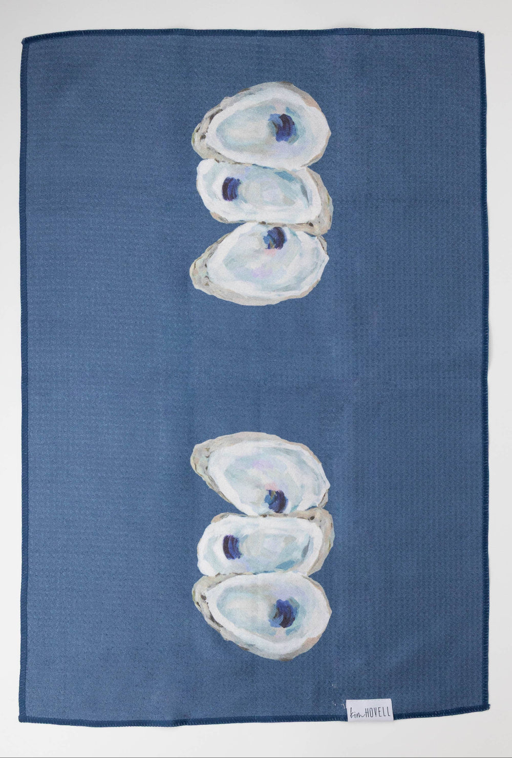 Blue towel with oyster shell design on a white background