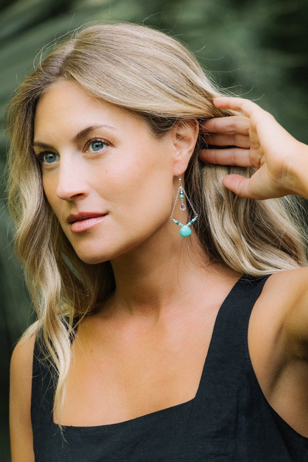 Woman showing off cooper chrysoprase earring
