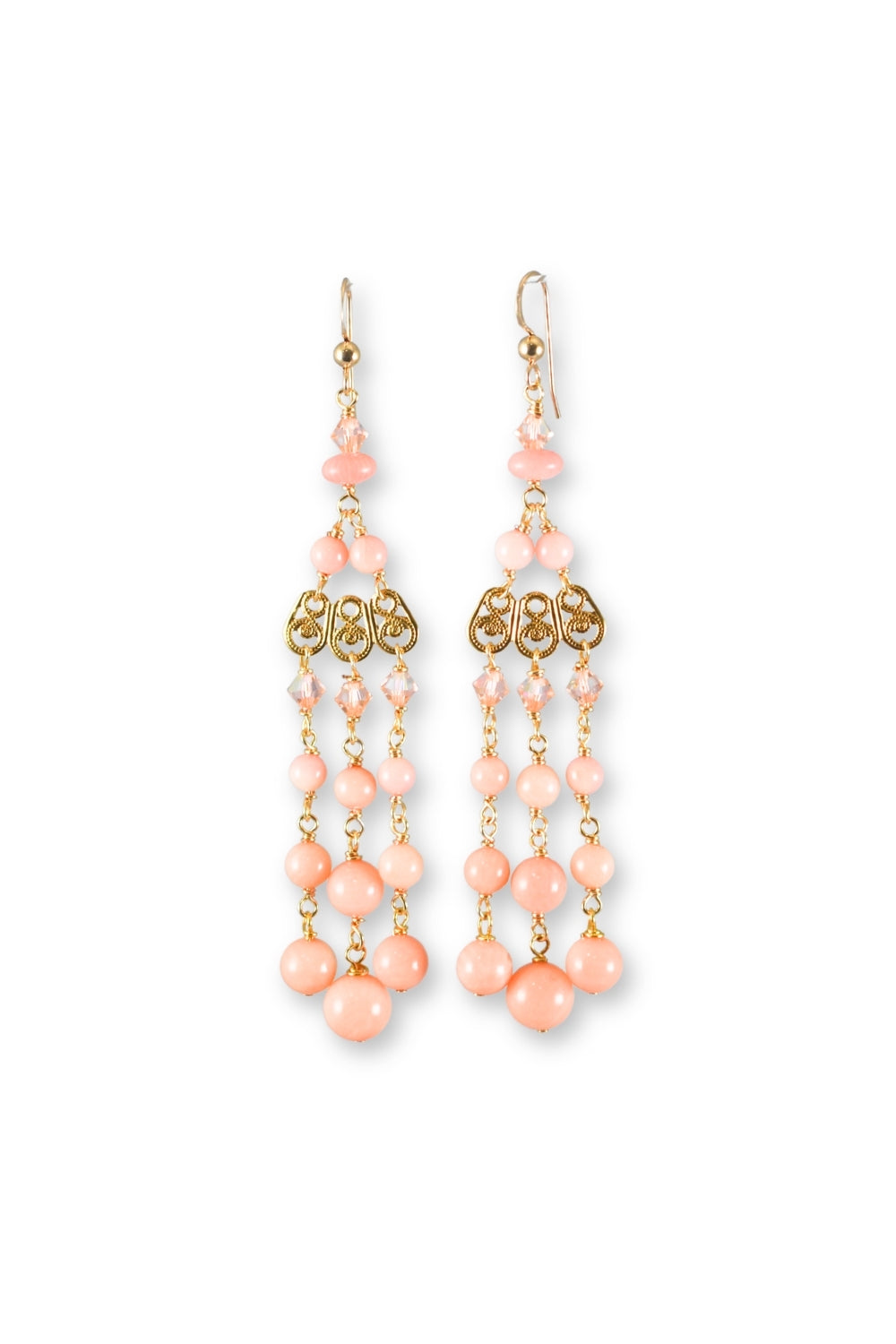 Peach-colored beaded earrings with gold accents on a white background