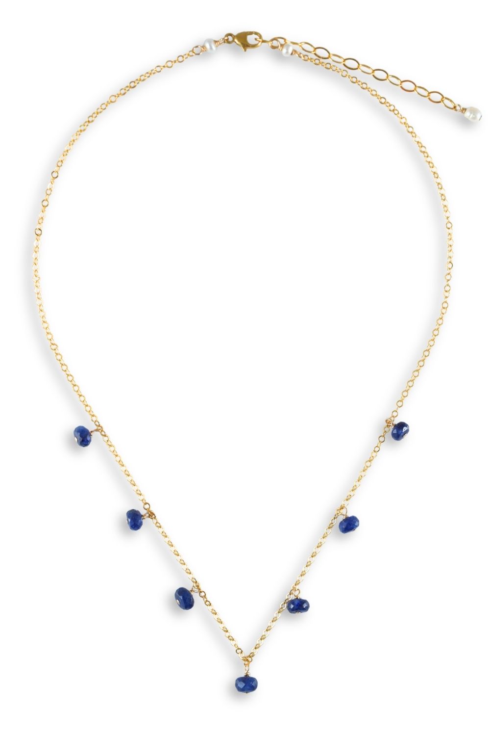 A delicate gold chain necklace featuring small, irregular dark blue gemstone accents spaced along the V-shaped drop, displayed on a clean white background.