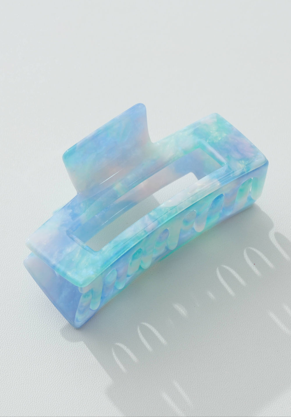Colorful rectangular hair clip on a light gray background