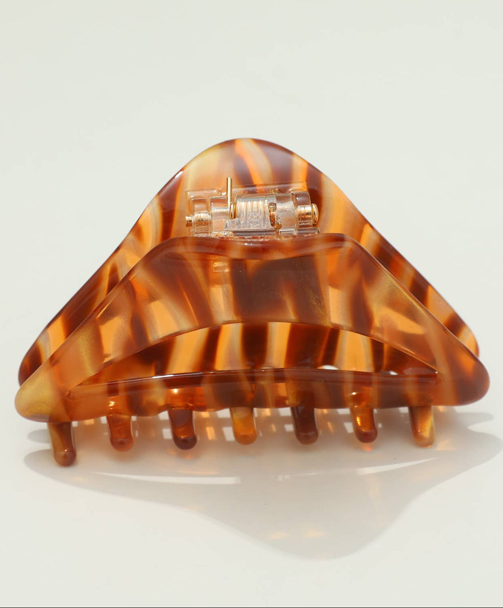 Tortoiseshell hair clip on a light gray background