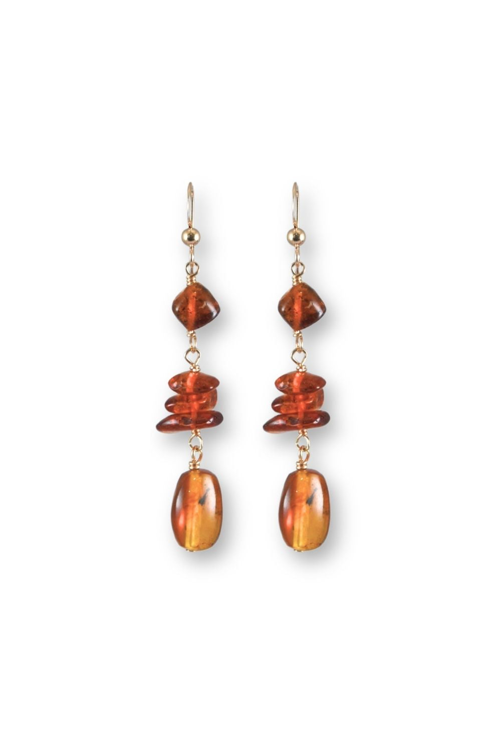 A pair of gold-tone dangle earrings featuring stacked amber and orange stone beads, shown against a plain white background.