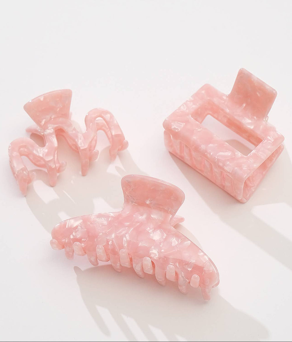 Set of pink hair clips on a white background