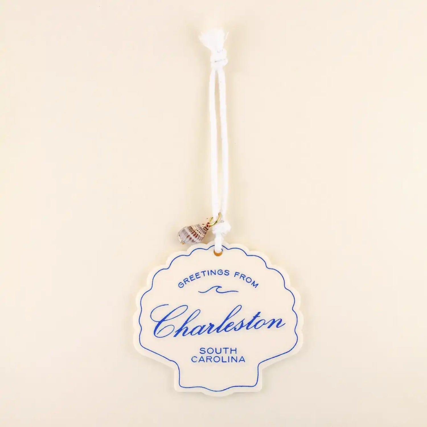 Decorative ornament with 'Greetings from Charleston, South Carolina' text on a beige background
