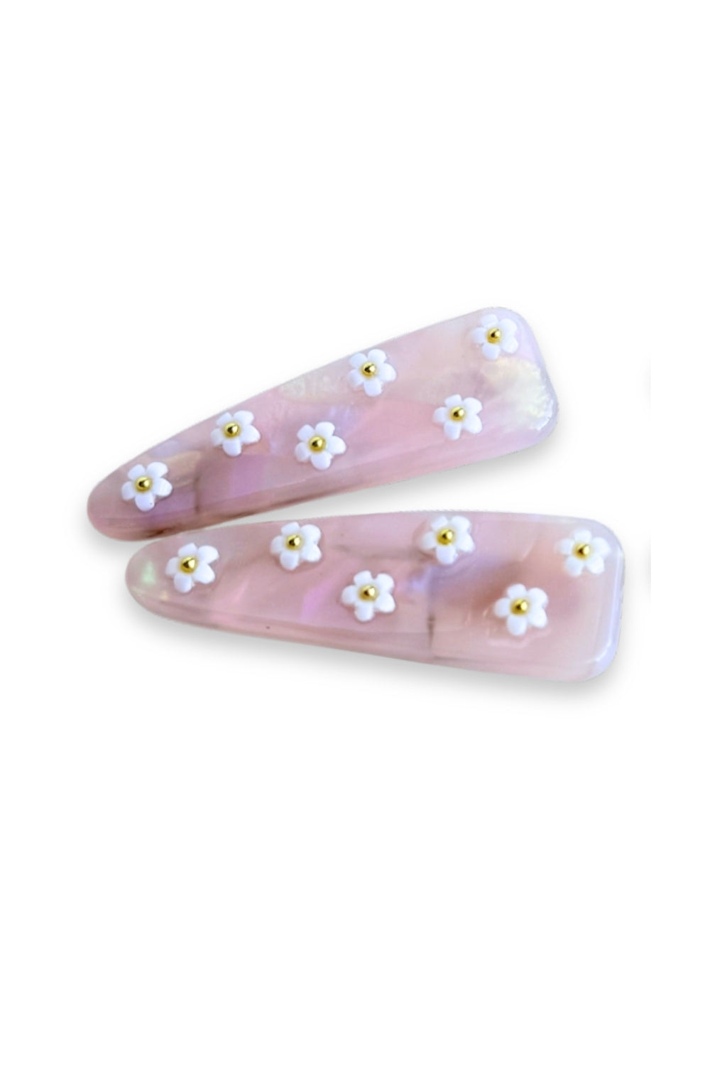 Two pink hair clips with white floral designs on a white background