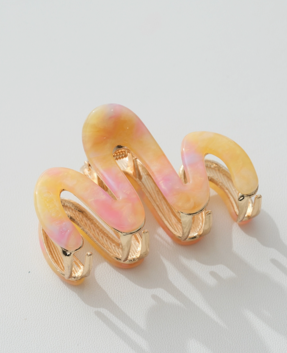 orange hair clips on a light background