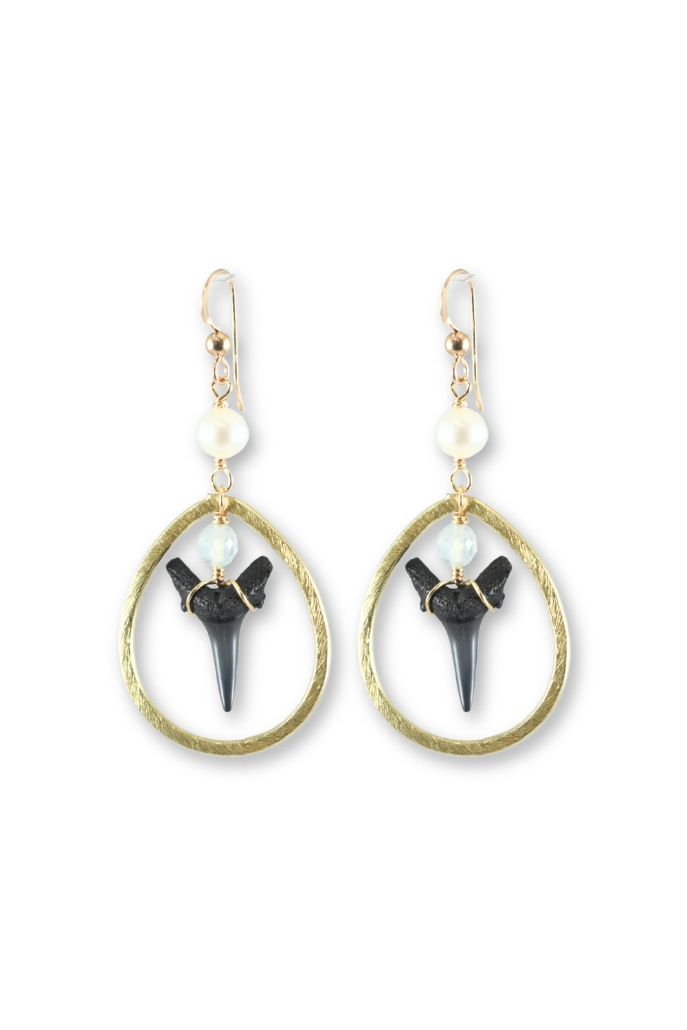 A pair of gold-tone dangle earrings featuring textured oval hoops, small white pearl beads, and black shark teeth, shown on a plain white background.
