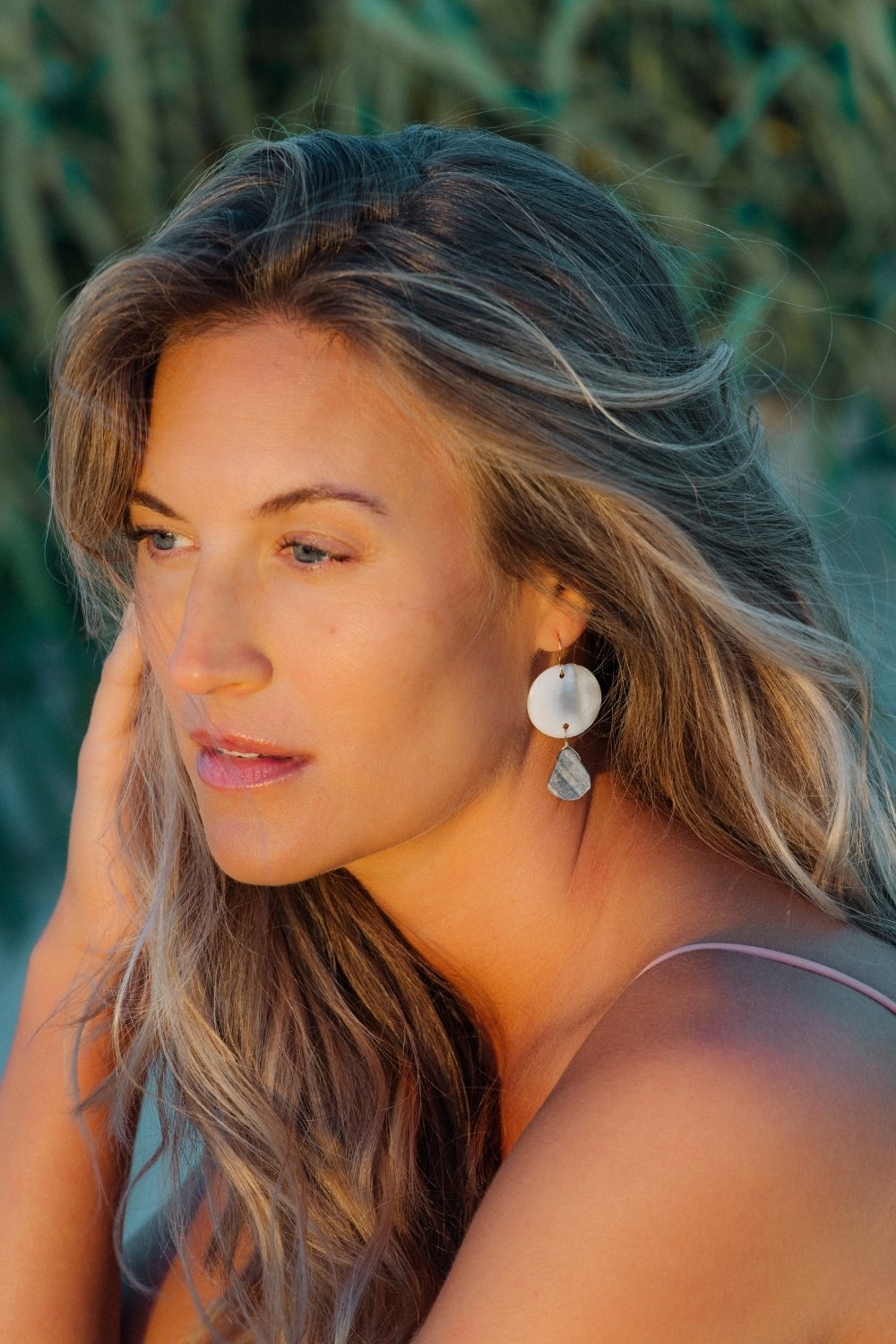 Woman with long blonde hair and the marina earrings 