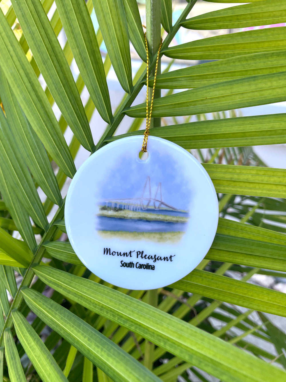 Mount Pleasant Ornament hanging in a palm frond