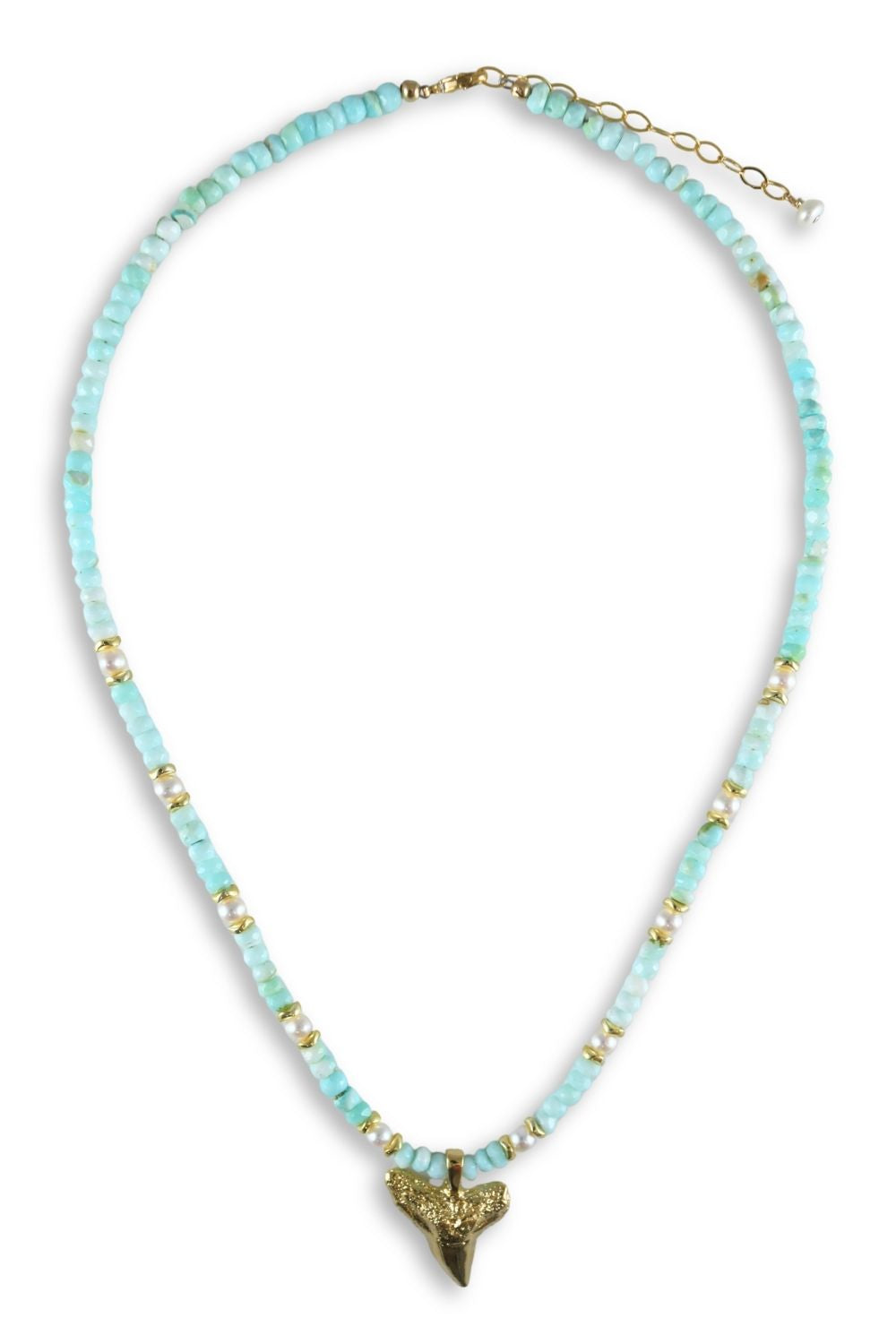 A beaded necklace featuring light blue-green faceted beads, accented with small gold spacers and a gold-tone shark tooth pendant at the center, displayed on a clean white background.