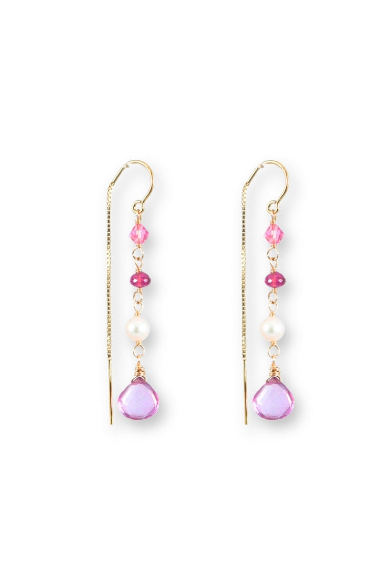 Pair of earrings with pink and purple beads on a white background