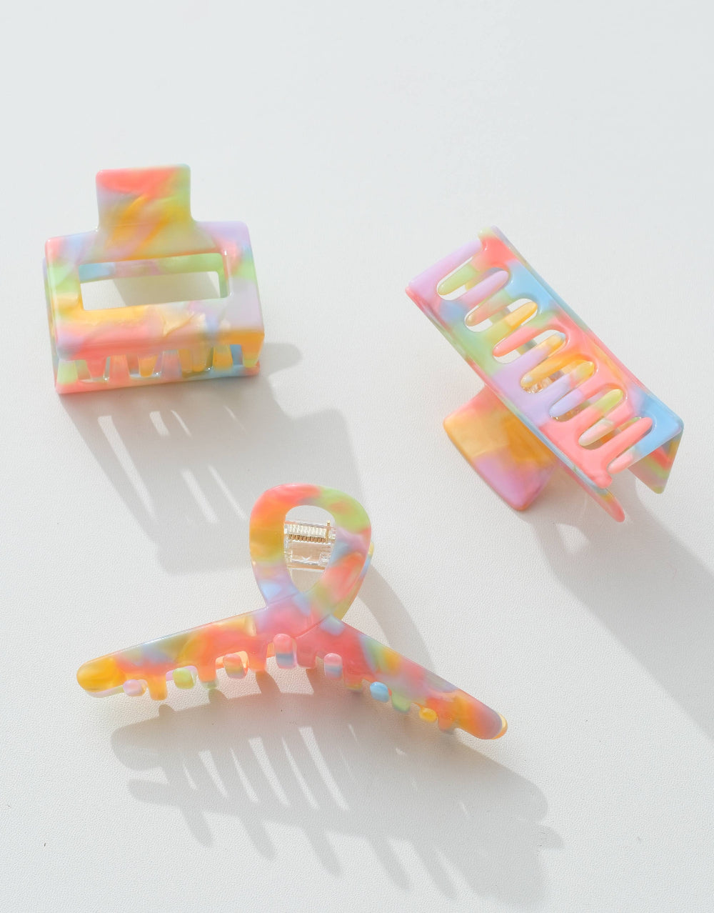 Three colorful hair clips on a white background
