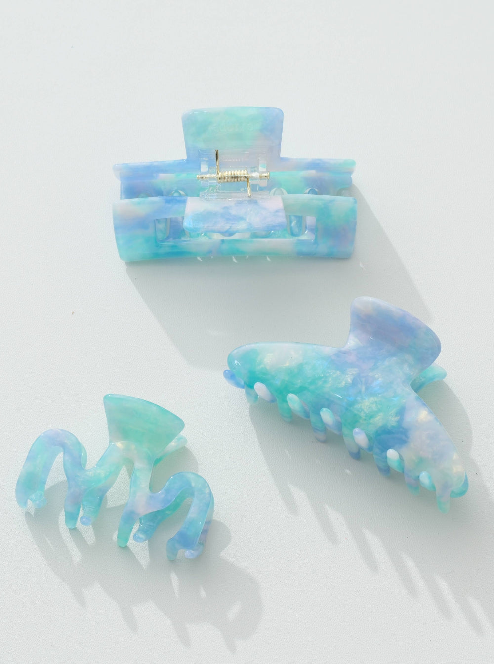 Set of blue and green hair clips on a white background