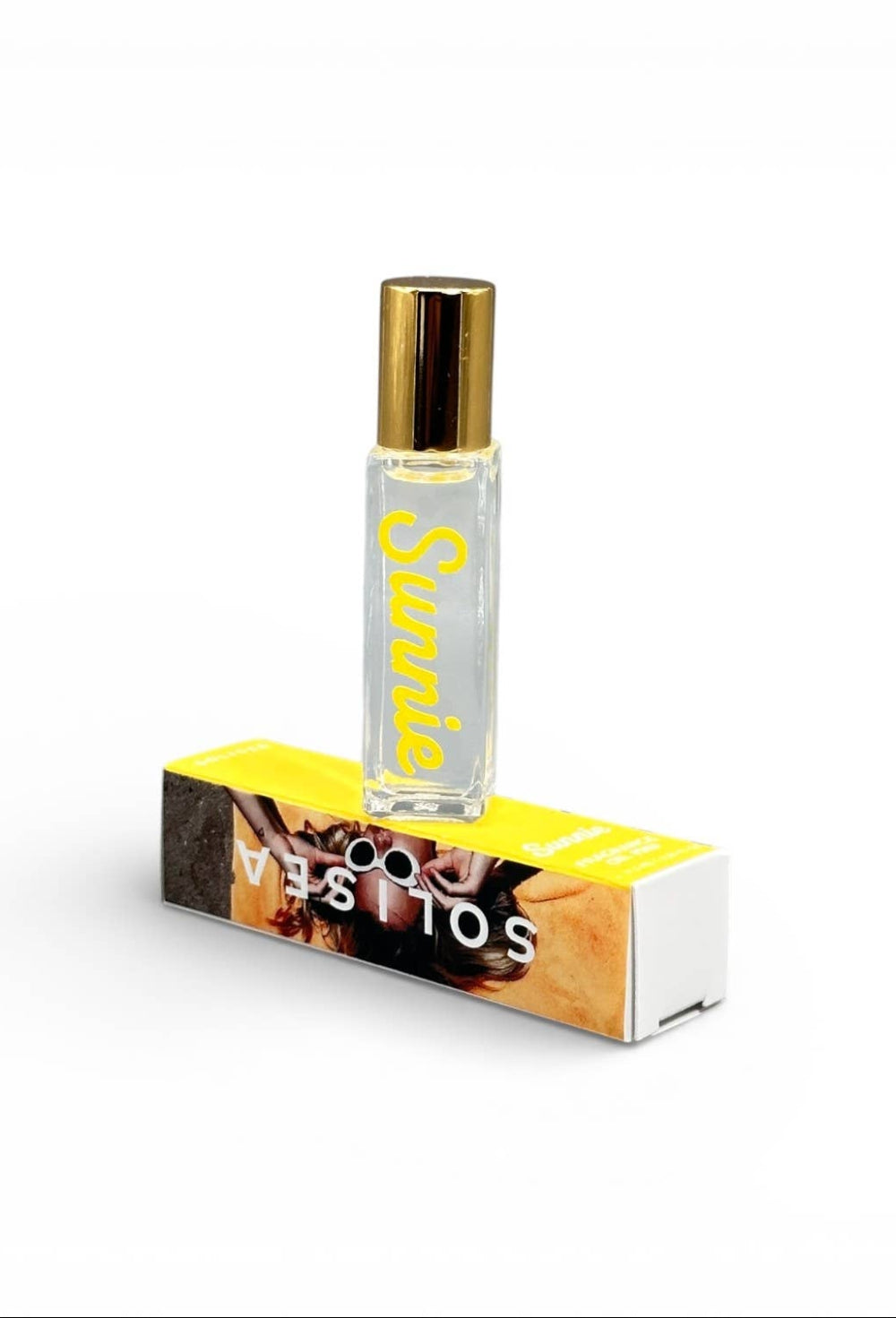 Roll-on bottle with gold cap and yellow box on a white background