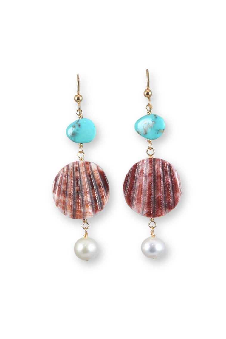Pair of earrings with shell and pearl elements on a white background