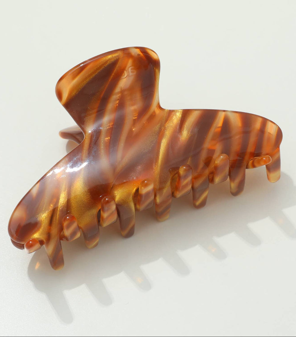 Tortoiseshell patterned hair clip on a white background