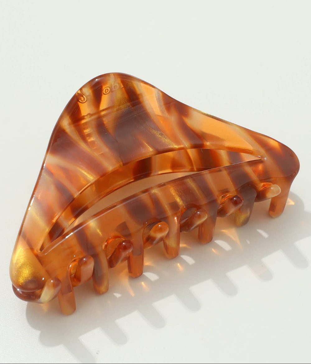Tortoiseshell patterned hair clip on a light gray background